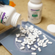 Pills of hydroxychloroquine being poured out by a pharmacy tech.